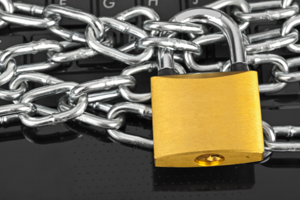 a padlock and chain over a computer keyboard