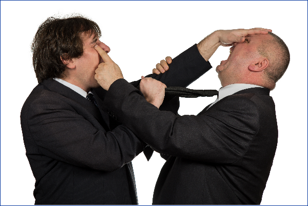 Two men in black suits fighting.