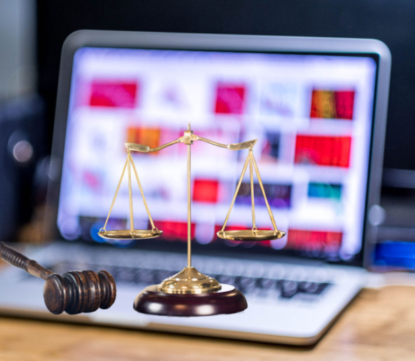 ADA Title II digital accessibility concept with scales of justice and gavel in front of a laptop, representing municipal record-keeping, public documents, and government website compliance with WCAG standards