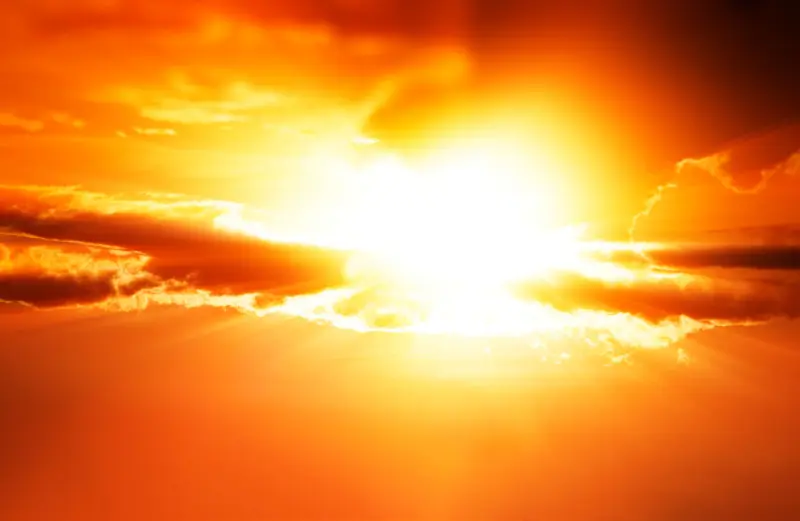 Bright orange sunset with sunburst, symbolizing extreme heat conditions for local government planning